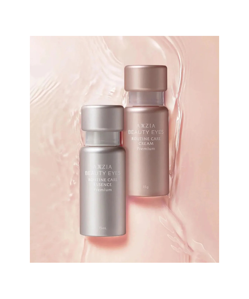 AXXZIA Beauty Eyes Routine Care Premium Cream i Essence – dwa flakony linii Beauty Eyes Routine Care Premium na różowym tle